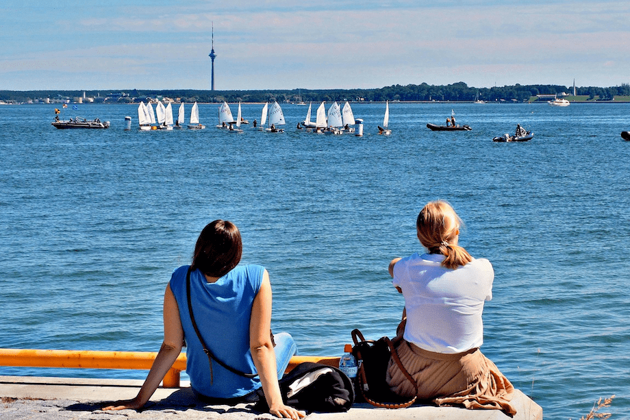2 women looking at the ocean discussing MHT in Australia and how they can find out more